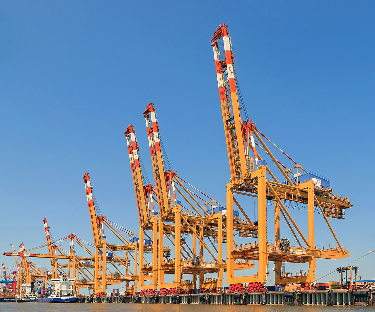 Container terminal with stacked shipping containers and cranes